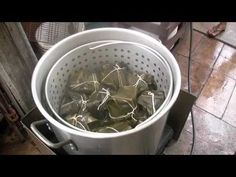 a pot filled with green leaves on top of a stove next to a heater