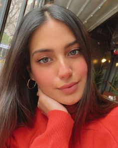 a close up of a person wearing a red sweater