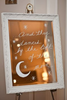 a sign that is on top of a tripod in front of a mirror with the words and they diamond if the light of the moon