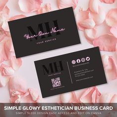 two black business cards with pink flowers on the bottom and one has a white letter mh