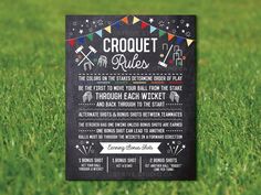 a chalkboard sign on the grass that says croquet rules, and an arrow