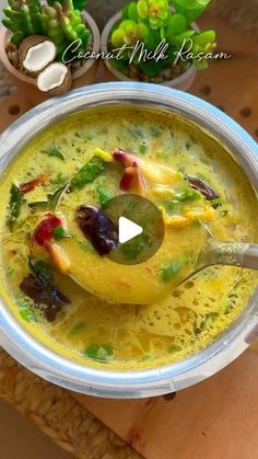 a bowl filled with yellow soup and vegetables