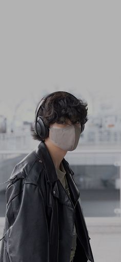 a man wearing headphones and a leather jacket