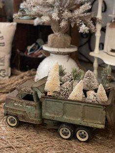 an old toy truck with christmas trees in the back