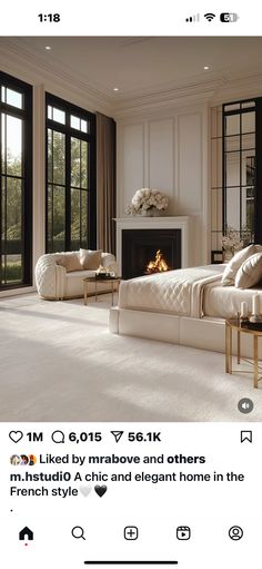 a large white bed sitting in a bedroom next to a fire place