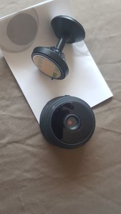 two black headphones sitting on top of a piece of paper next to each other