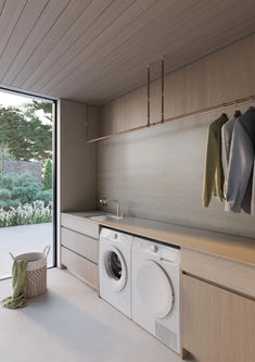 a washer and dryer in a room with sliding glass doors to the outside