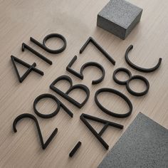 Love ❤️ Decors - Black Floating House Numbers Our black house numbers are easy to install and bring a modern touch to your home. They are made with with high-quality zinc alloy material with a smooth gloss black coating. They stand out beautifully due to their striking black finish, sure to grab anyone's attention. We wanted our house numbers to be a focal piece for anyone walking by, we created four different house numbers so you have a choice of which colour. They come in a black, gold, White Suspended House, Black House Numbers, Modern Black House, Address Signs, New Homeowner Gift, Door Numbers, House Doors, Wall Plug, Address Sign