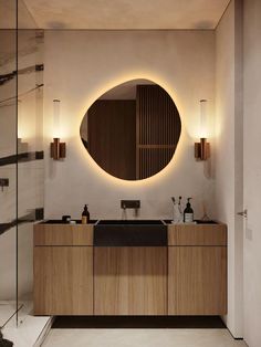 a bathroom with a round mirror above the sink