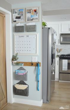 a refrigerator with magnets and pictures on the wall next to an open door in a kitchen