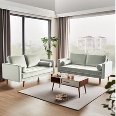 a living room with two couches and a coffee table in front of large windows