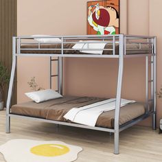 a metal bunk bed sitting on top of a hard wood floor next to a wall