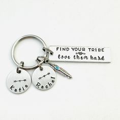 two personalized key chains with the words find your tribe and love them hard