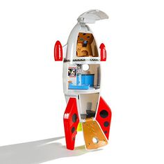 a toy rocket ship that is on display for kids to play with in the room