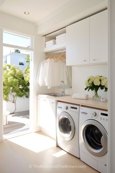 a washer and dryer in a white laundry room with open doors to the outside