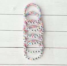 🧁Fun sprinkle heishi bead bracelets for back to school! Personalize with your child's new grade level or their name and choose the color heart bead you prefer.  🧁Type in grade level or child's name in the personalization section. Choose bracelet size and heart bead color and add to cart! 🧁The bracelet is made with polymer clay heishi beads and acrylic white and black letter beads.  🧁Please measure your wrist for the sizing that you want made. XXS- 5.5 inches XS- 6.0 inches S-6.5 inches M- 7.0 inches L-7.5 inches 🧁Please be sure to check spelling of name you want before ordering. 🧁Each bracelet is custom made so all sales are final and no refunds will be issued. Please check all size and personalization prior to ordering.  🧁Tips: Do not get bracelets wet. They may tarnish. Please rem Cheap Playful Bracelets For School, Clay Activities For Kids Bracelet, Back To School Bracelets For Kids, Back To School Bracelet Ideas, Kid Beaded Bracelets, Back To School Clay Bead Bracelets, Personalized Pink Bracelets For School, Personalized Multicolor Bracelets For School, Personalized Multicolor Beaded Bracelets For School