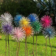 four colorful glass flowers in the grass