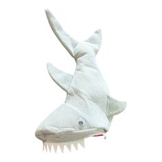 a white stuffed shark head with teeth on it's face and one eye open