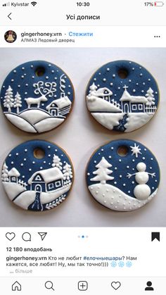 four decorated christmas cookies on top of each other with snow and houses in the background