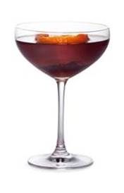 a wine glass filled with red liquid and orange peels