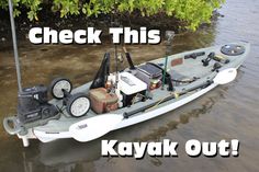 a kayak is sitting in the water with its gear on it's side