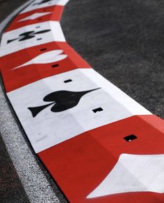 a red and white street sign sitting on the side of a road