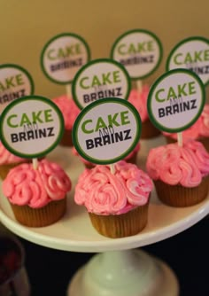 cupcakes with pink frosting and green labels on them