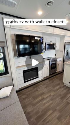 the interior of an rv with white cabinets and wood flooring is shown in this video