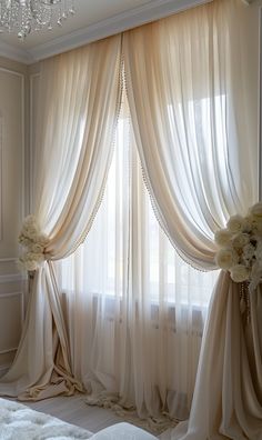 an elegant bedroom with white flowers and curtains