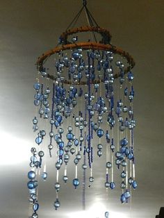 a chandelier with blue glass beads hanging from it's centerpieces