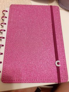 a pink notebook sitting on top of a table