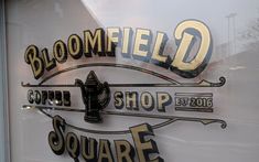 there is a sign that says bloomfield square on the side of a store window