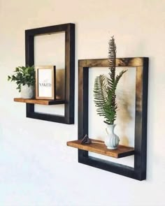 three wooden shelves with plants and pictures on them