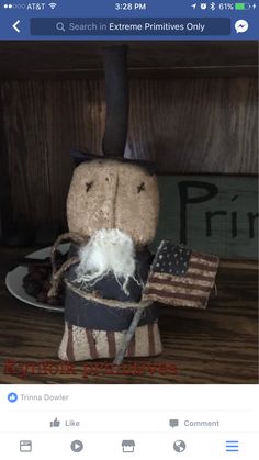 a stuffed animal is sitting on top of an american flag hat and other items in the background