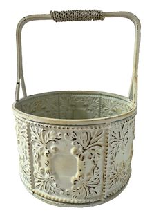 an old white metal basket with handles