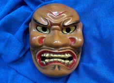 "Japanese ceramic mask Shikami. The Shikami is a demon mask with features like furrowed brows, fang-like teeth and a snarling mouth. This mask is used to display ferocious expressions and thereby, the nature of demons. Electric-fired. Height 9.3\" (23.6 cm) Width 7.5\" (19.1 cm) The colors of the item may vary slightly due to computer monitor settings." Demon Mask, Ceramic Mask, Japanese Tea Ceremony, Matcha Bowl, Beautiful Storage, Electric Fires, Japanese Ceramics, Japanese Tea, Tea Ceremony