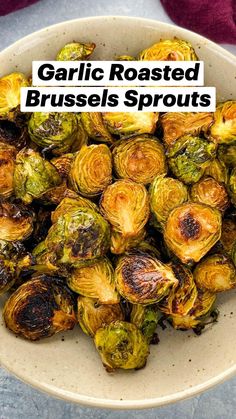 a white bowl filled with brussel sprouts on top of a table