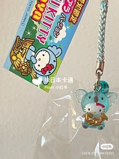 a hello kitty keychain hanging from a lanyard with an id card attached to it