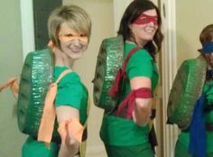 three women in green shirts and ties are wearing costumes that look like they have masks on their faces