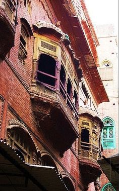 an old building with many balconies and windows on the outside, in india