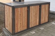 an outdoor storage unit with wood panels and metal accents