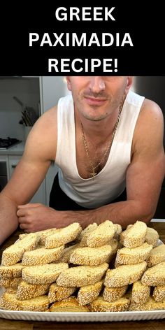 a man sitting in front of a pile of pastries with the words greek paxmadia recipe