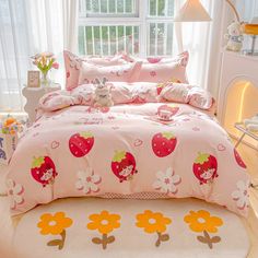 a bed covered in pink and orange strawberry print sheets