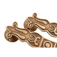 two wooden door handles with designs on them