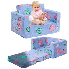 a baby sitting in a blue chair with pink and green designs on it's back