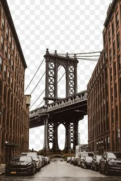 cars parked on the street in front of tall buildings with a bridge above them,