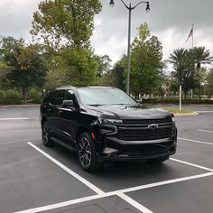 a black suv parked in a parking lot