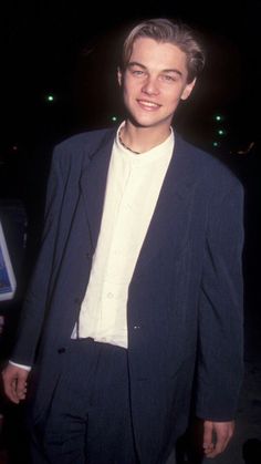 the young man is wearing a suit and white shirt