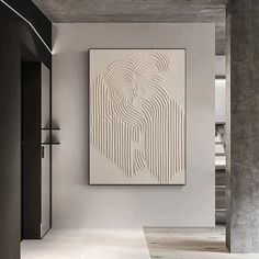 an abstract painting hangs on the wall next to a door in a room with concrete floors