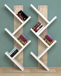 two bookshelves are stacked on top of each other in front of a wall